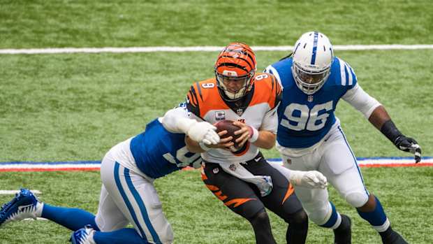 Indianapolis Colts defensive tackle DeForest Buckner (left) and defensive end Denico Autry (96) converge on Cincinnati Bengals quarterback Joe Burrow for a sack.